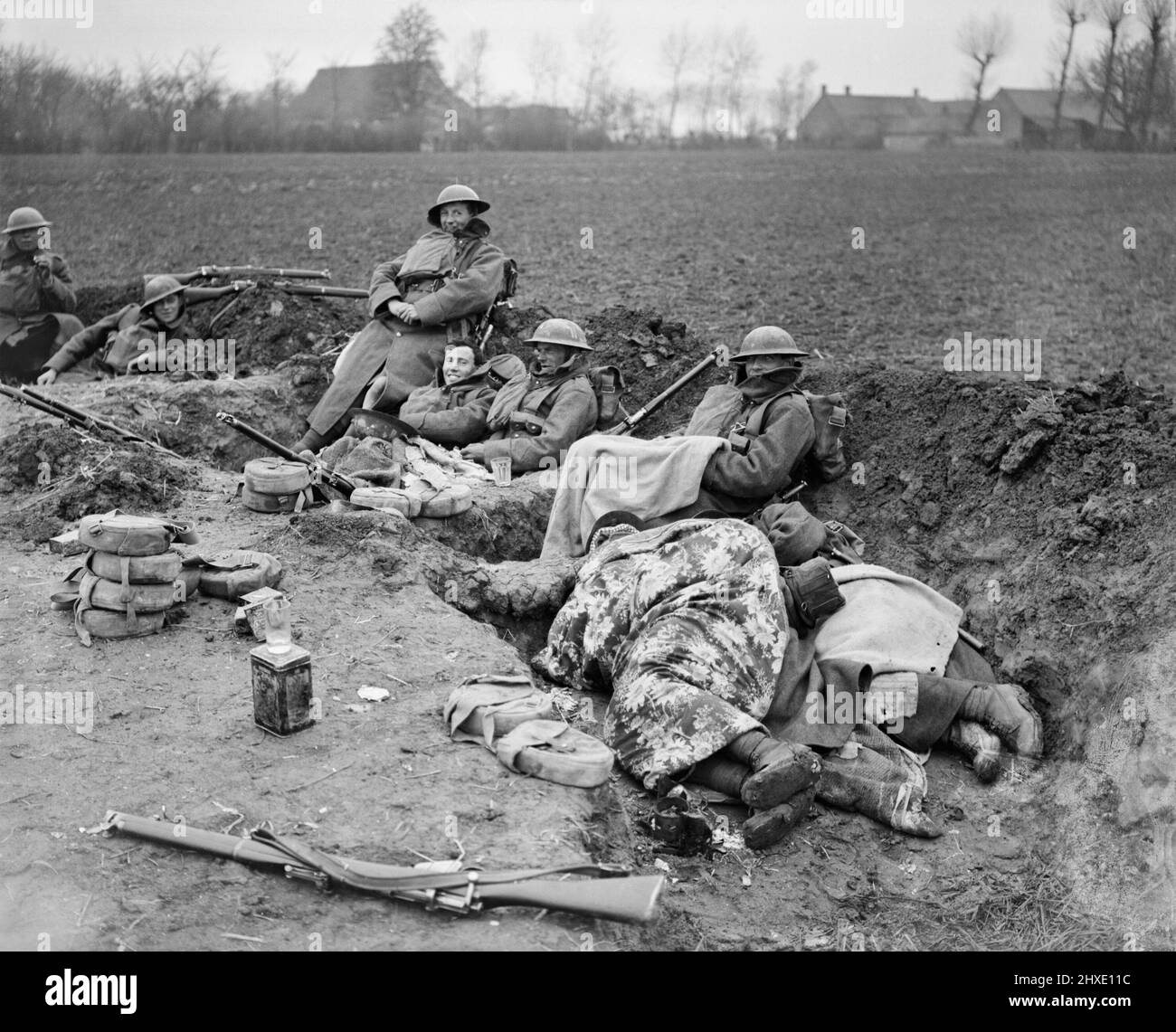 Men of the 51st Division resting in a hastily dug trench during the German spring offensiove, 10 April 1918. Stock Photo