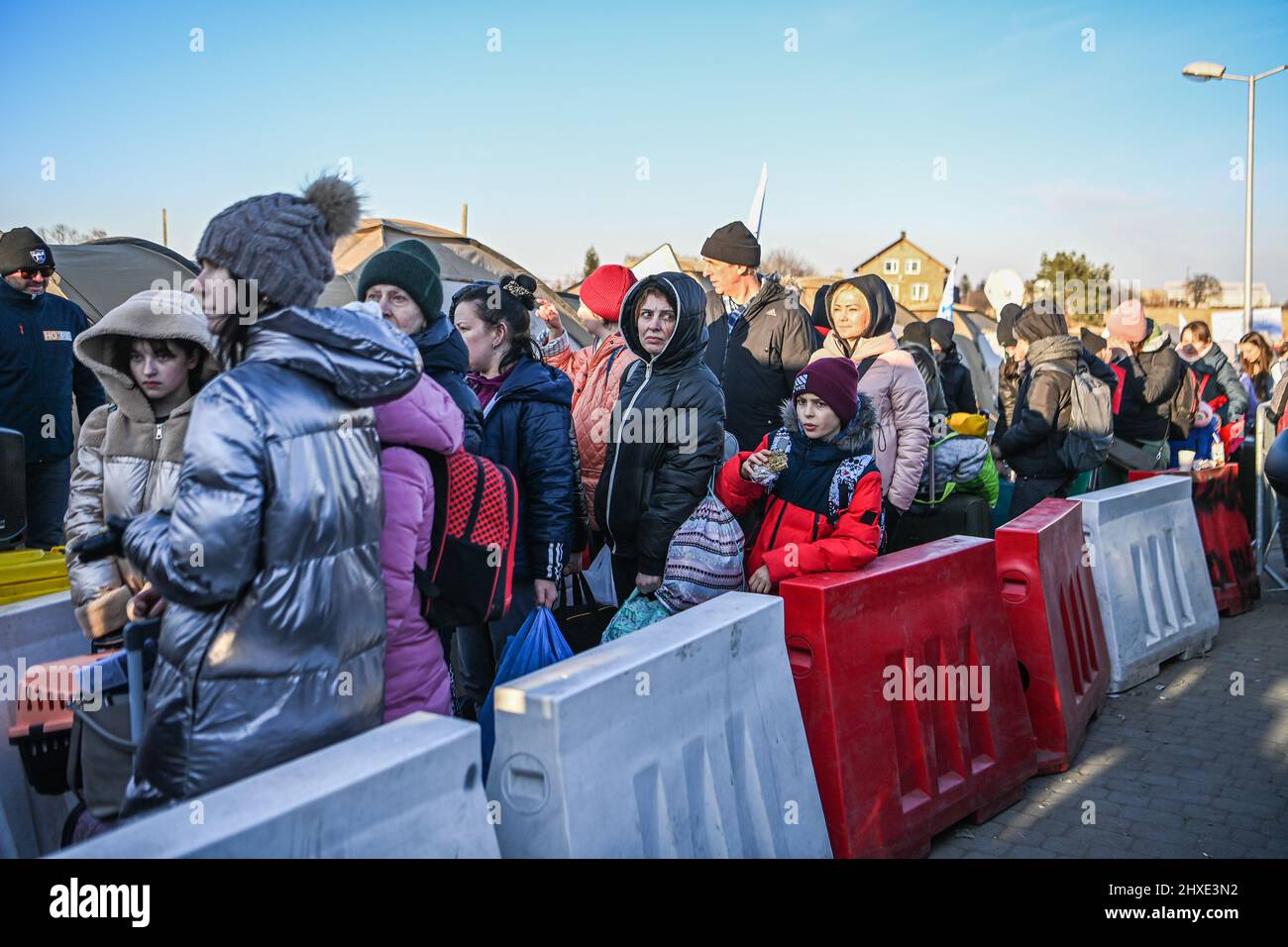 Medyka, Poland. 11th Mar, 2022. Ukrainian refugees wait to board busses. Medyka border crossing on the 16th day of the Russian invasion in Ukraine. (Photo by Laurel Chor/SOPA Images/Sipa USA) Credit: Sipa USA/Alamy Live News Stock Photo