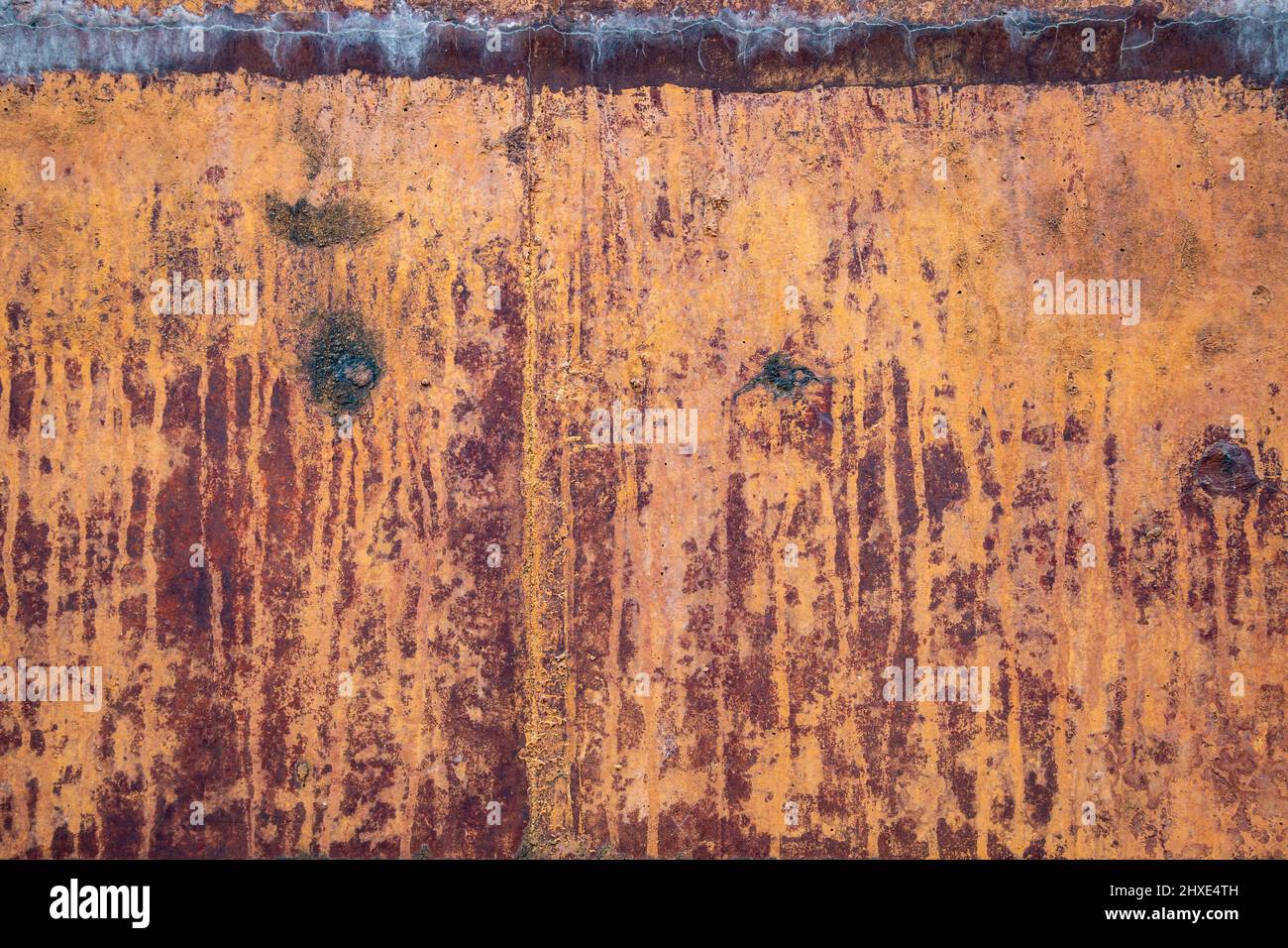 Rusty stained and marked stone wall for texture or background Stock Photo