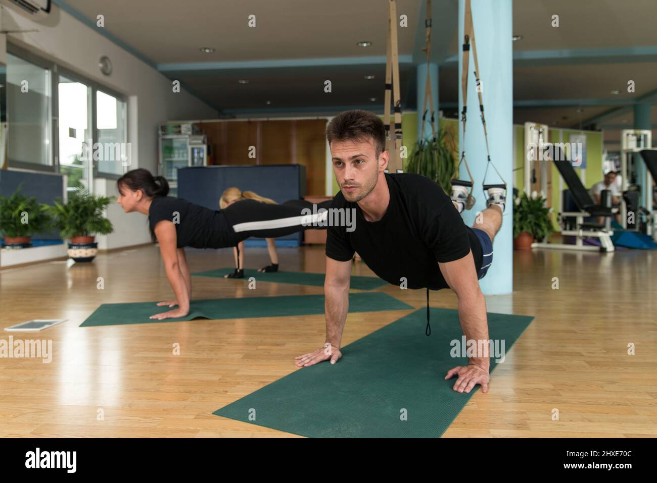 Fitness Group of People Doing Suspension Training Trx Exercises With ...