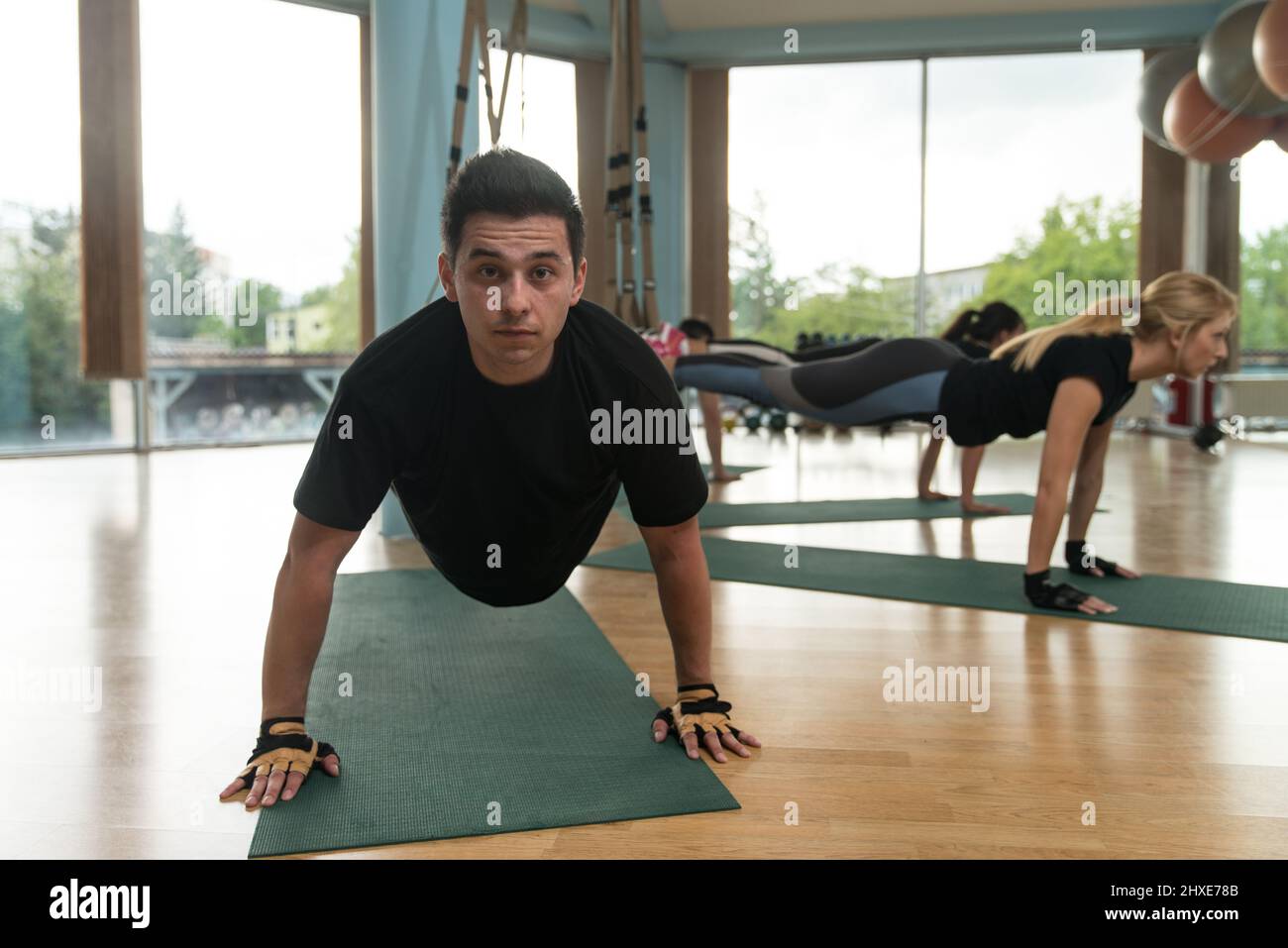 Fitness Group of People Doing Suspension Training Trx Exercises With ...