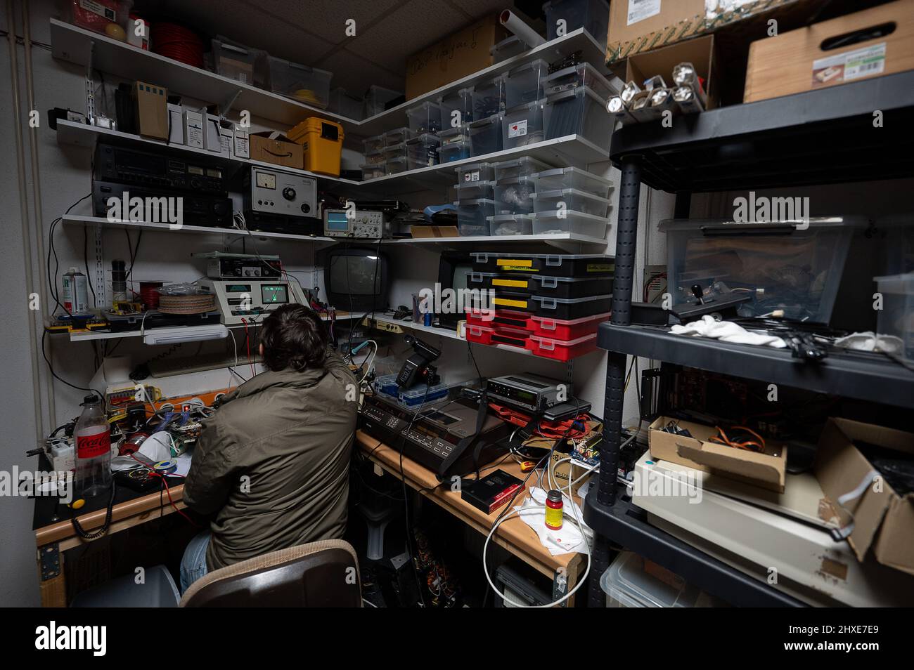 Seligenstadt, Germany. 05th Mar, 2022. Employee Simon has in the pinball  and arcade museum sits in the workshop. The museum, which is run by the  association For Amusement Only, is open to