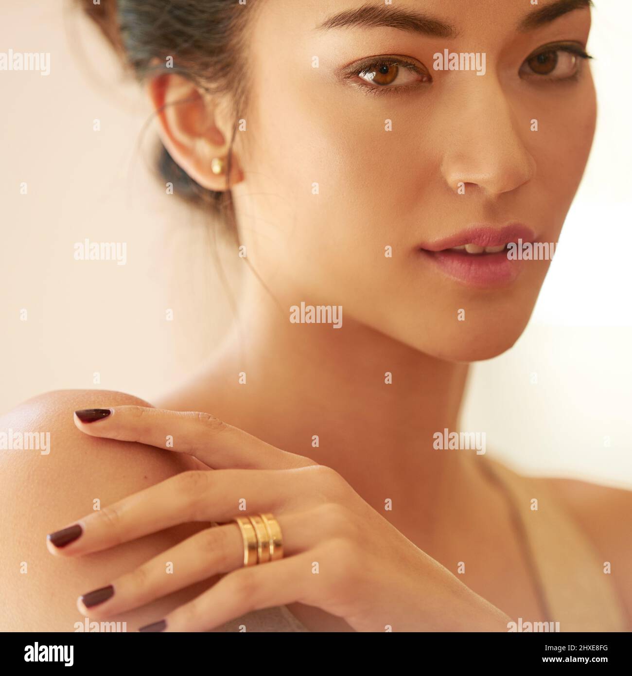 Golden allure. Closeup portrait of a beautiful young woman dressed ...