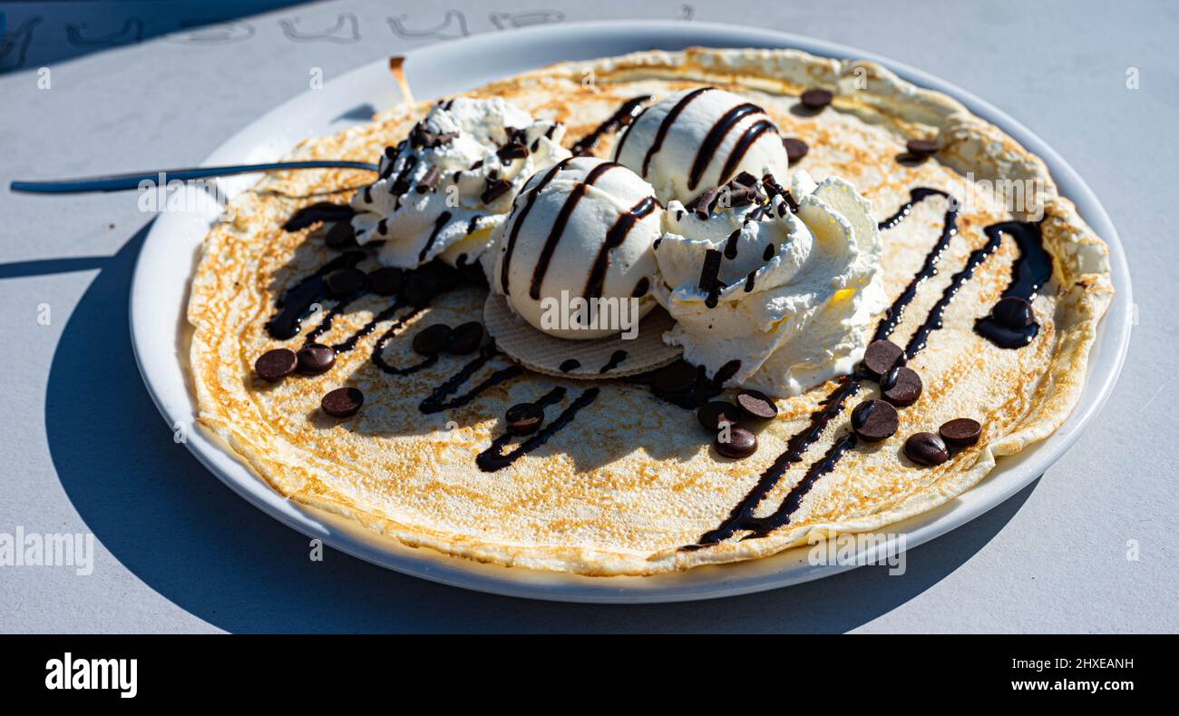 Dame blanche (vanilla ice with hot chocolate) pancake on a plate served in  a restaurant Stock Photo - Alamy