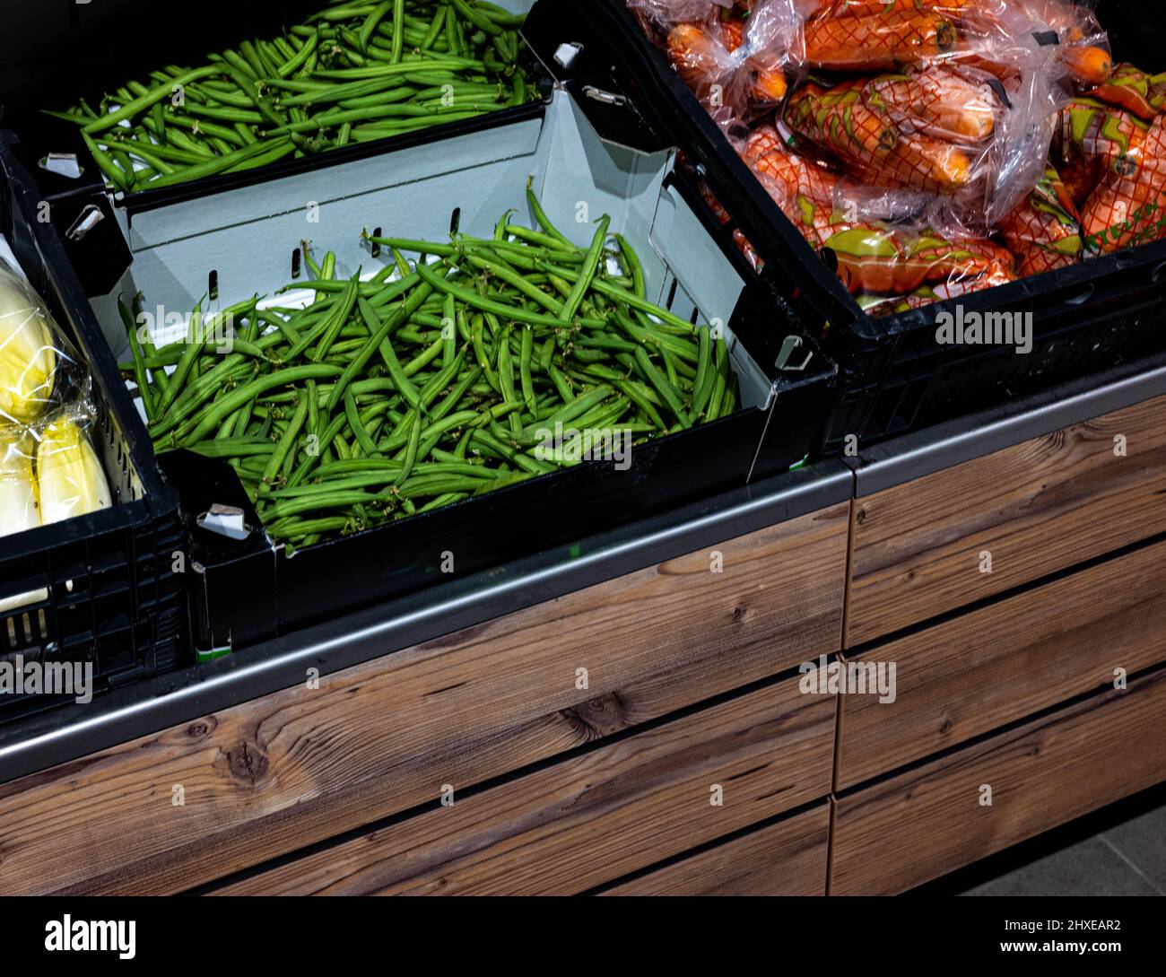 Different kinds of vegetables in fruit basket displays in a supermarket