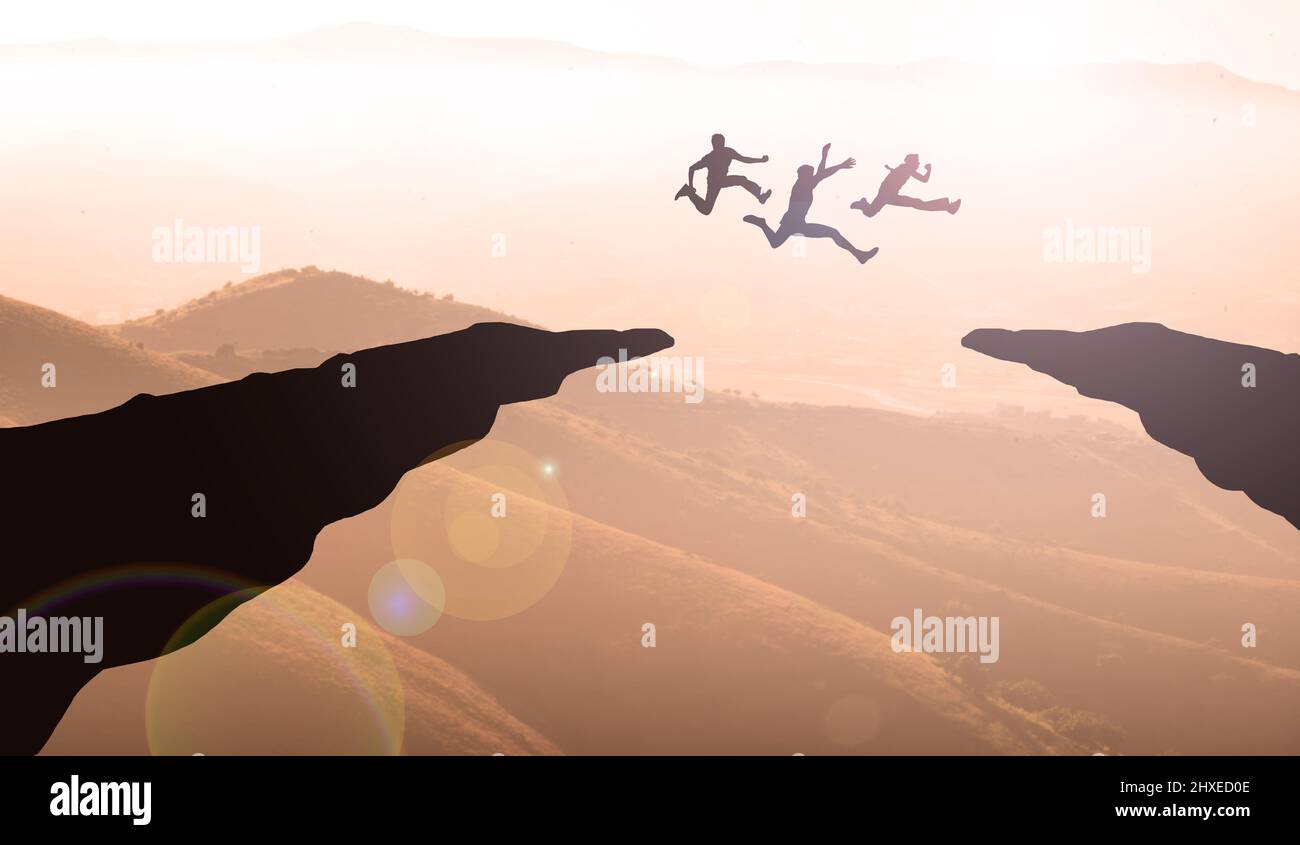 Business Team Jumping Together Over Cliff Maintains. Teamwork Goals, Challenge and Competition Concept. Stock Photo