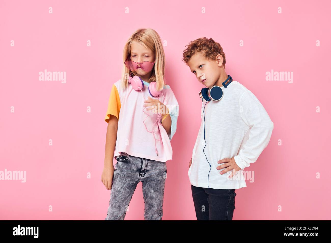 adorable little kids wearing headphones posing studio posing Stock