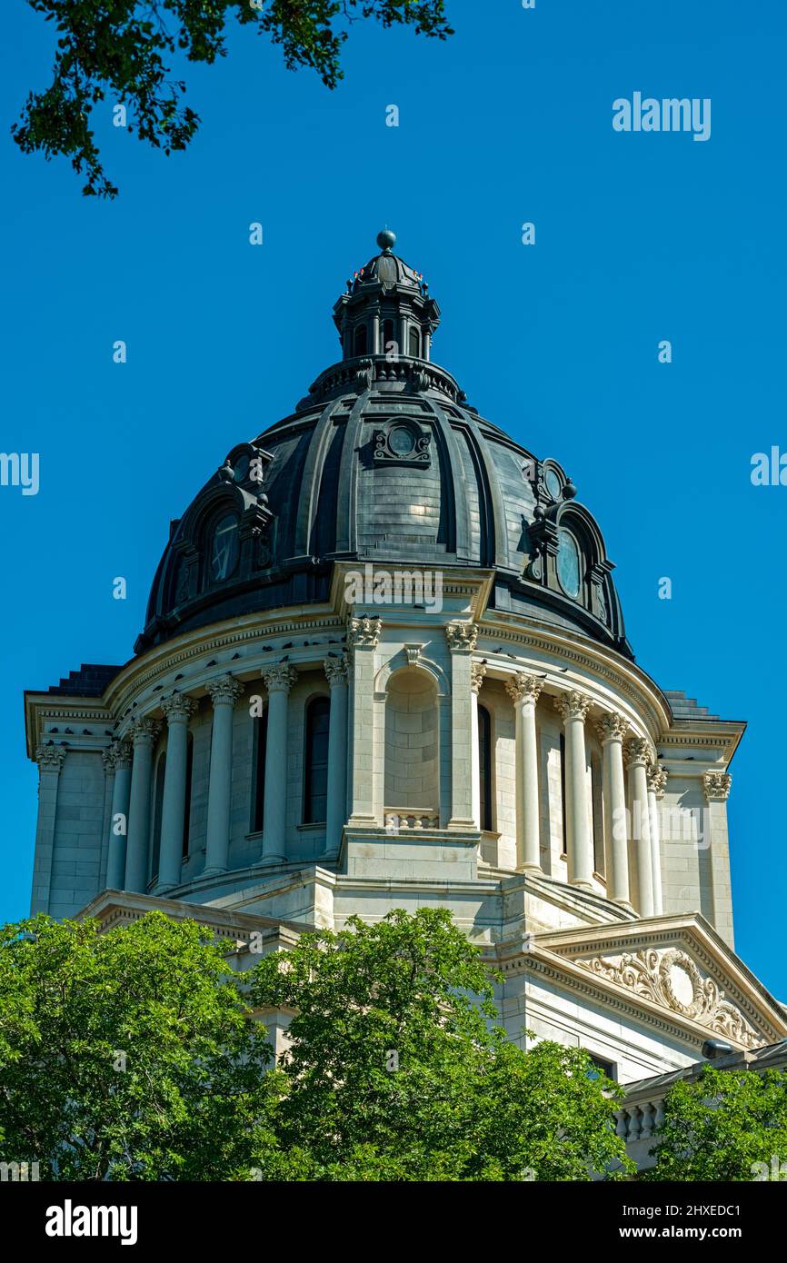 The dome of the State Capitol framed by trees in Pierre, South Dakota, USA Stock Photo