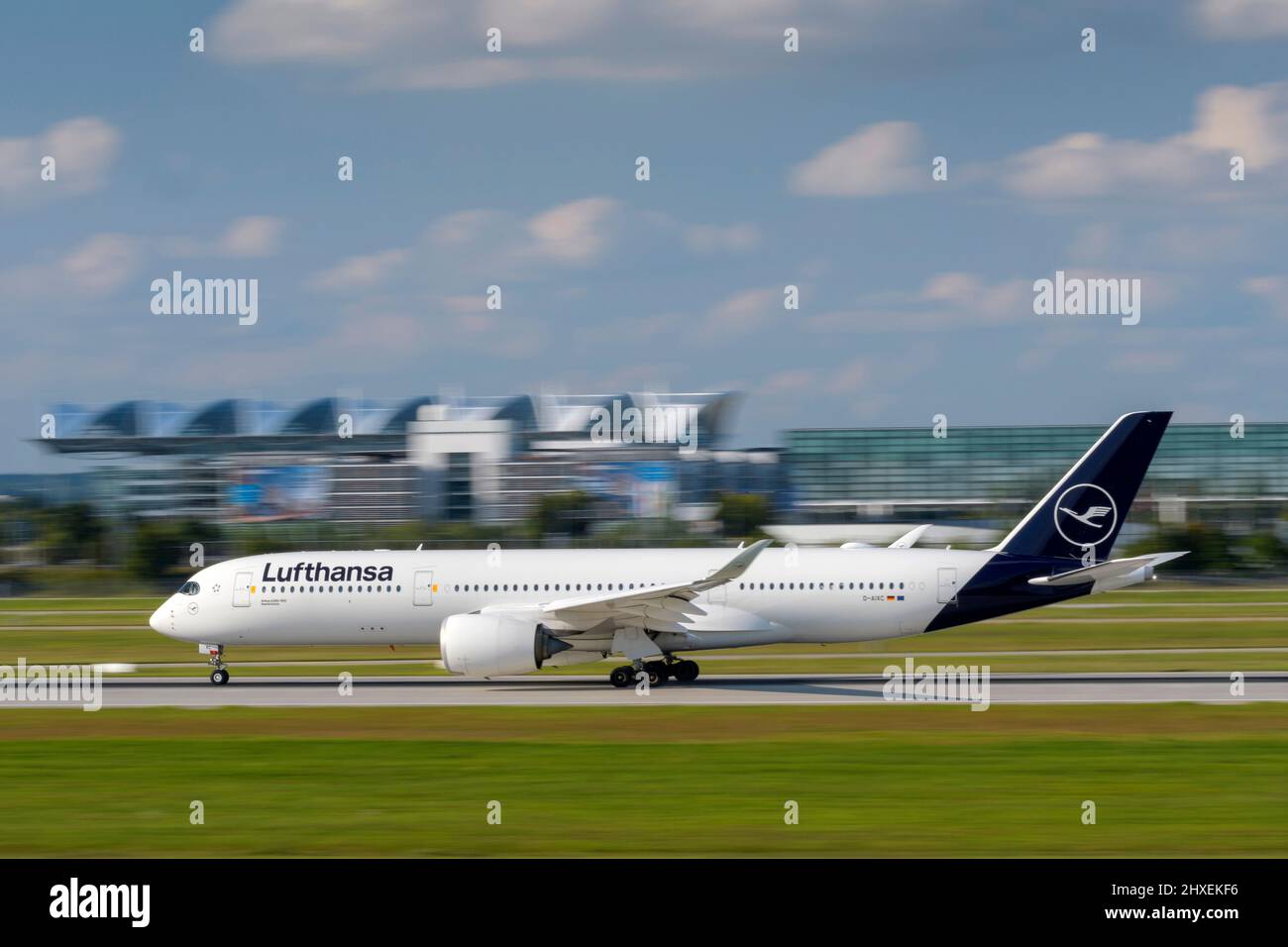 Munich, Germany - September 12. 2021: Lufthansa Airbus A350-941 with the aircraft registration D-AIXC is starting on the southern runway 26L of the Mu Stock Photo