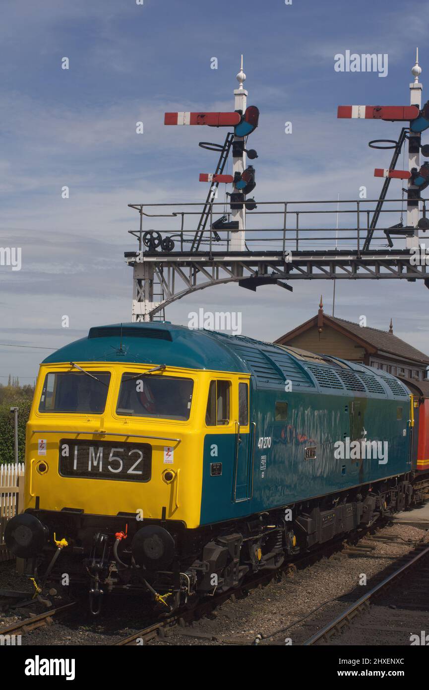 Class 47 British diesel locomotive 47270 Swift, under a pair of semaphore signals, Nene Valley Railway, UK. Stock Photo