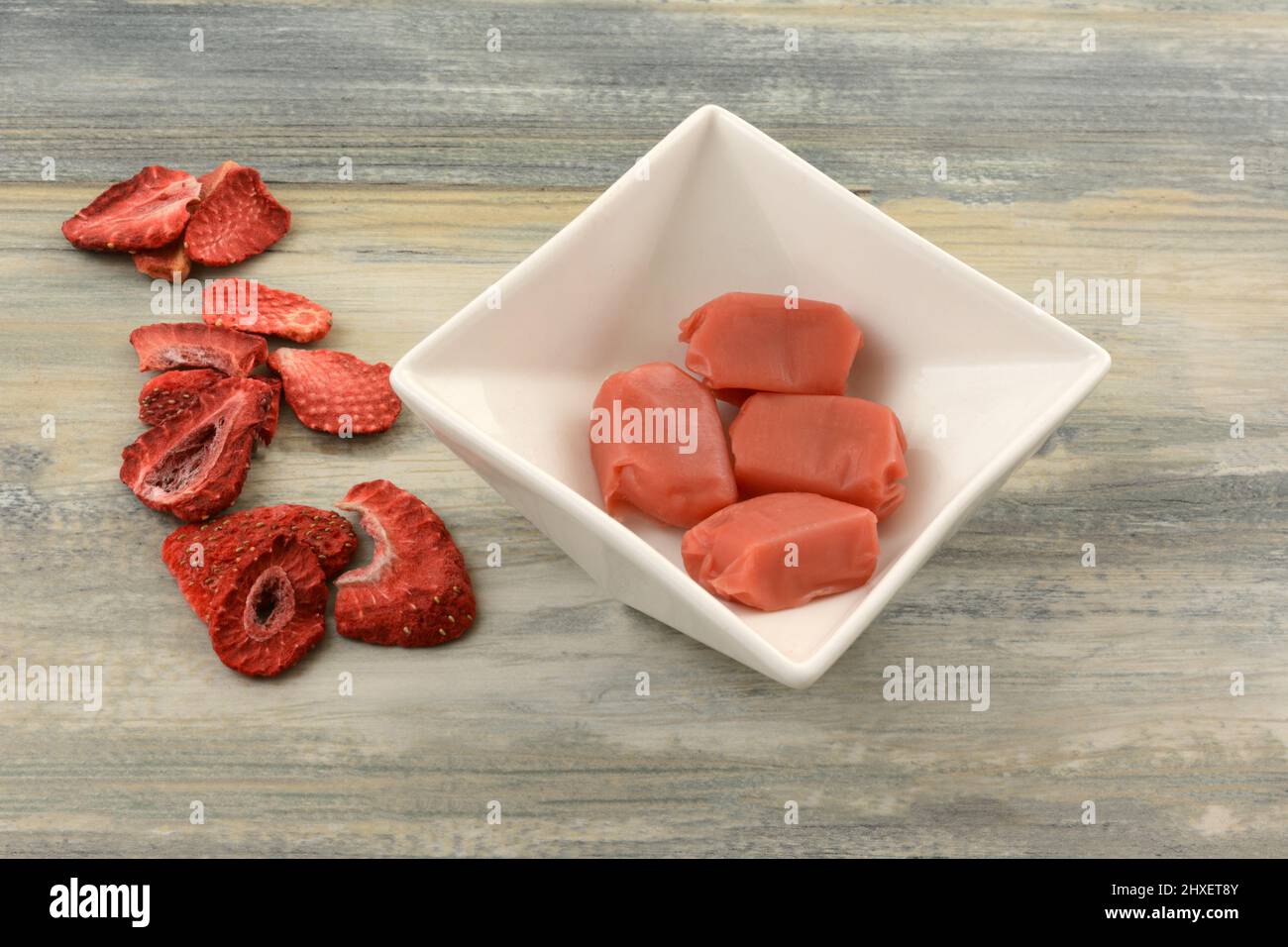 Strawberry toffee pieces in white candy dish and freeze dried