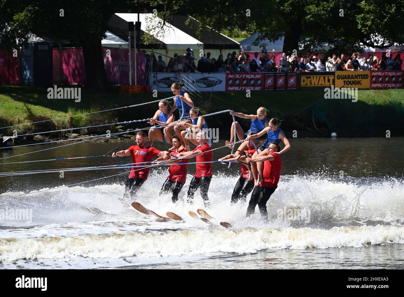 Water-skiers dismounting from a pyramid foundation while travelling along the Yarra River during the 2022 Moomba Masters Ski Show Stock Photo
