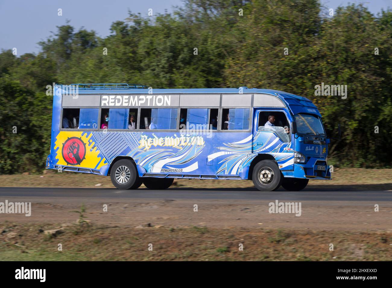 Bus with customised paintwork driving along Magadi Road, Langata. Many buses in Nairobi have custom paintwork, a wide range of subjects are painted, i Stock Photo