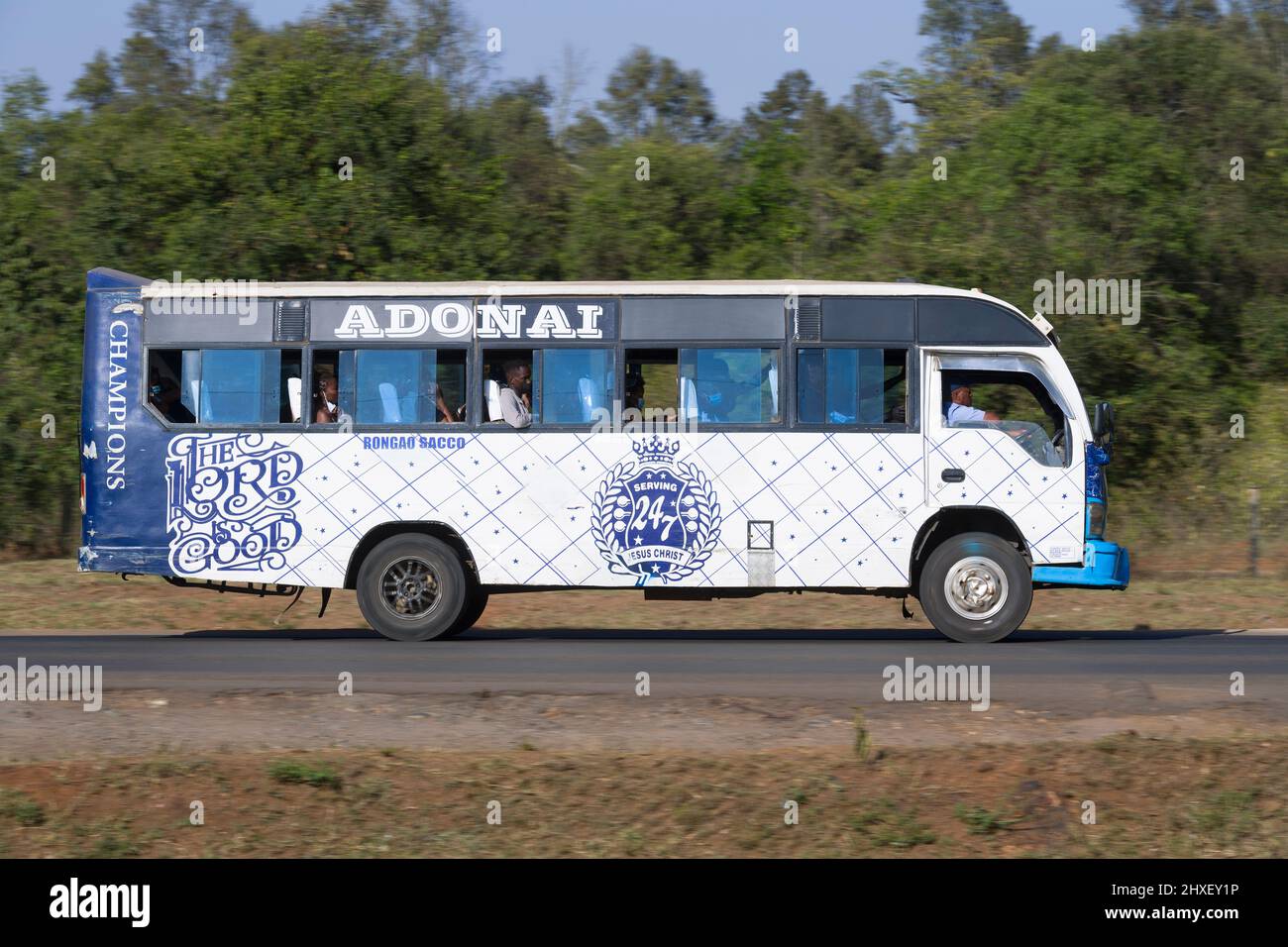 Bus with customised paintwork driving along Magadi Road, Langata. Many buses in Nairobi have custom paintwork, a wide range of subjects are painted, i Stock Photo