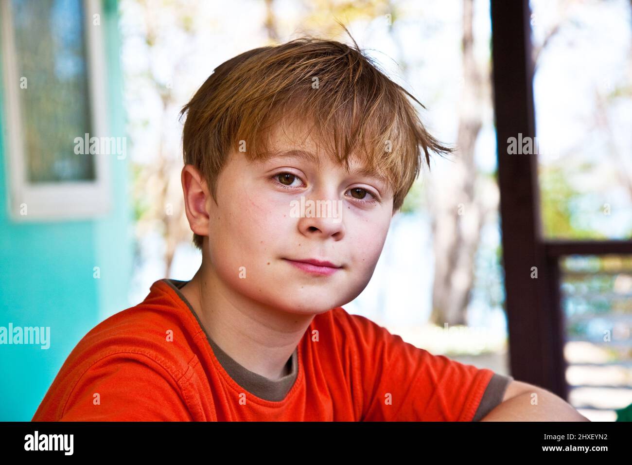 boy with brown eyes is looking self confident and happy Stock Photo Alamy
