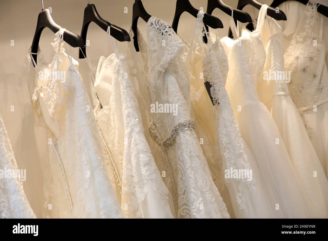 A selection of white wedding dresses pictured in a dress shop in