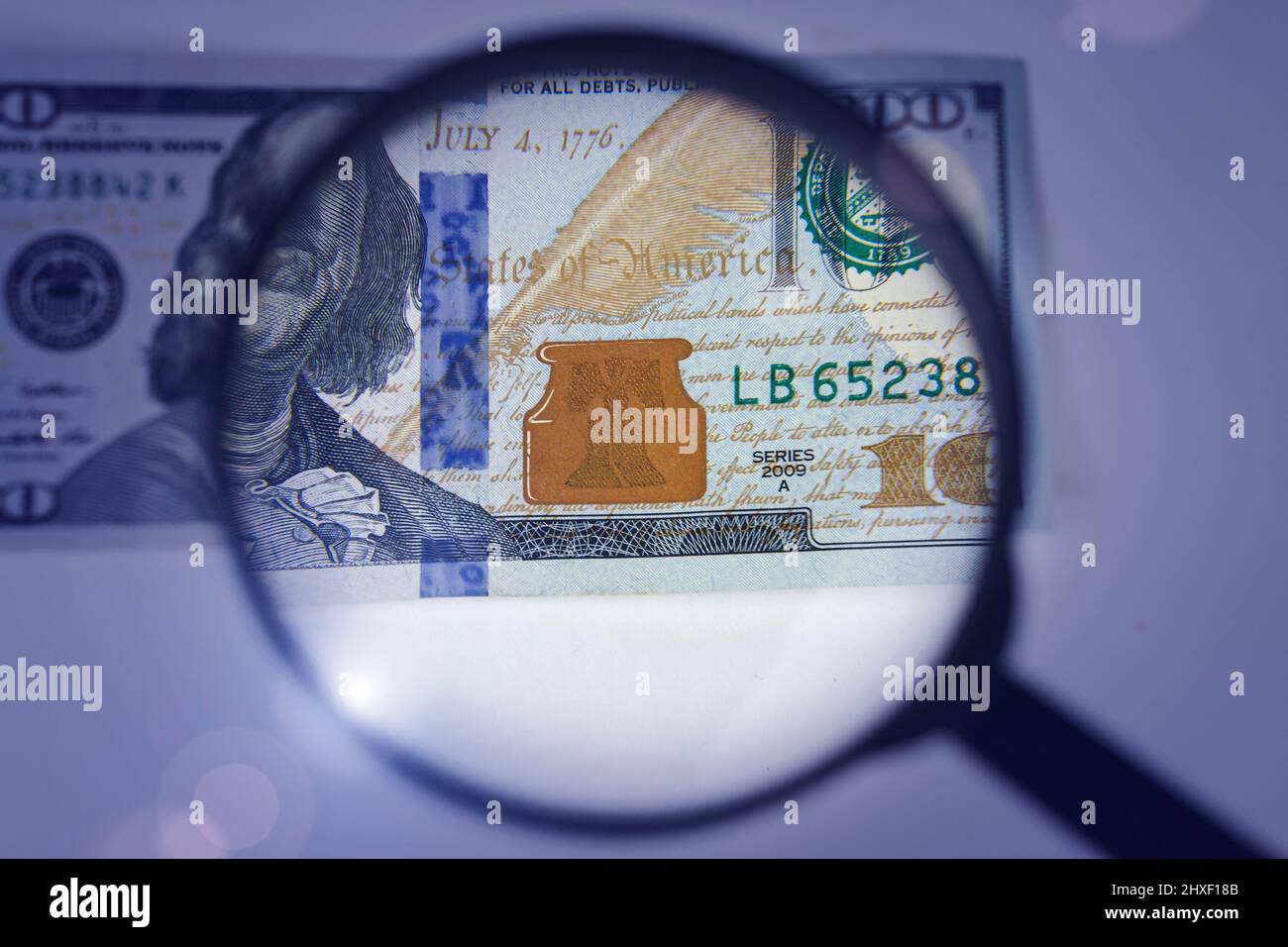 Magnifying glass on dollar banknotes. Hundred dollars banknote ...