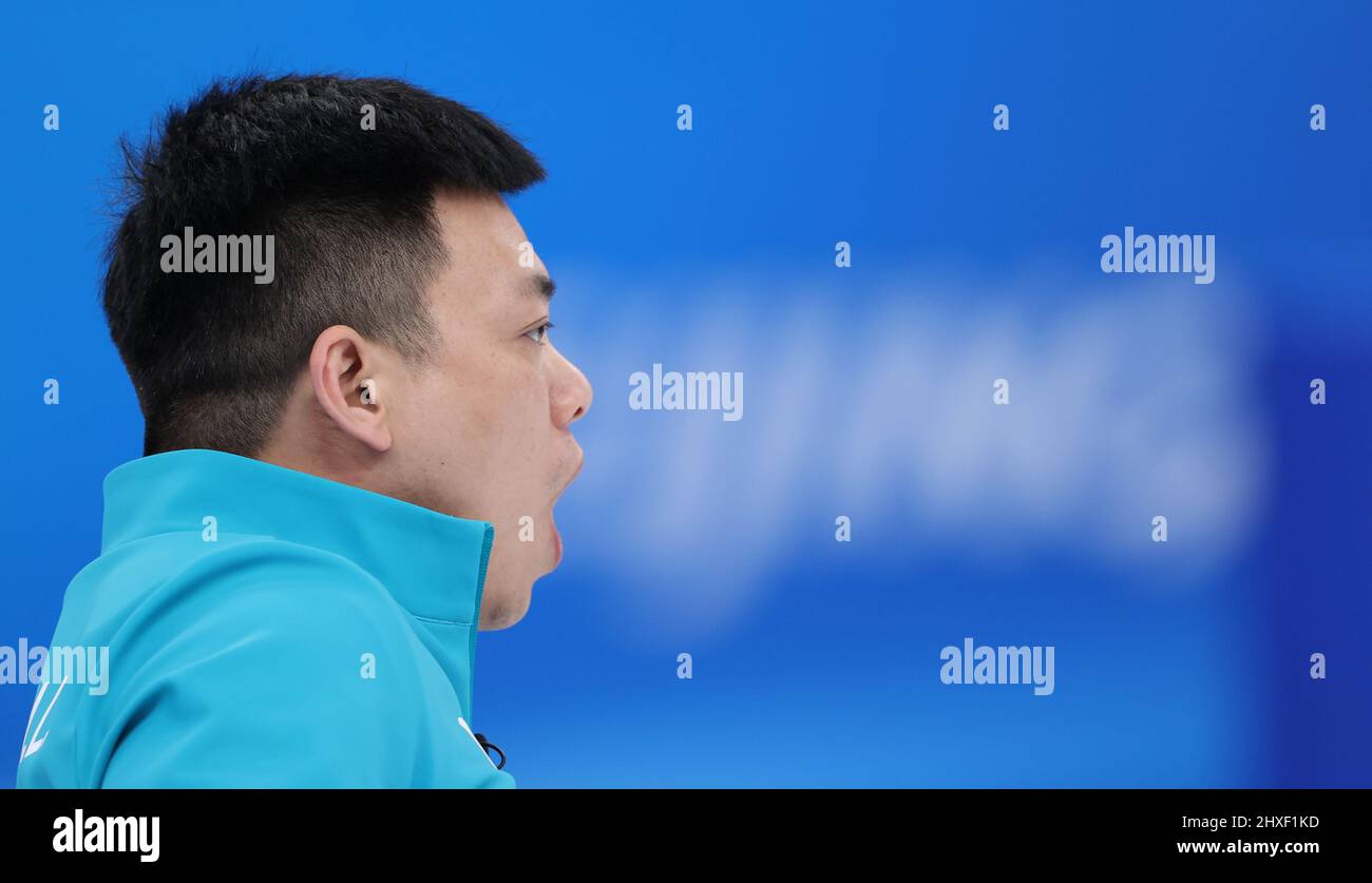 Beijing, China. 12th Mar, 2022. Zhang Mingliang of China reacts during ...