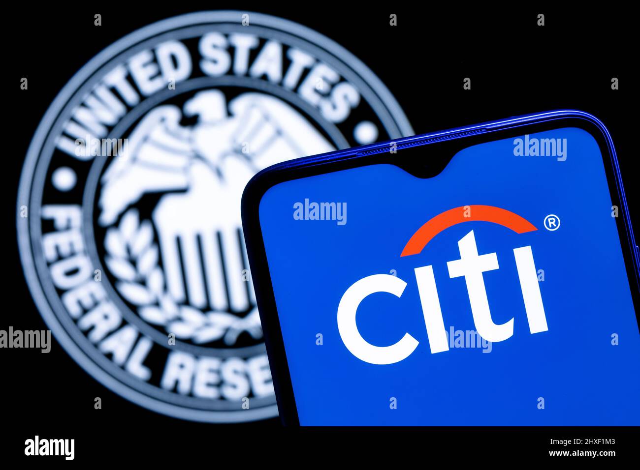 Smartphone with Citigroup logo on background of Federal Reserve symbol Stock Photo