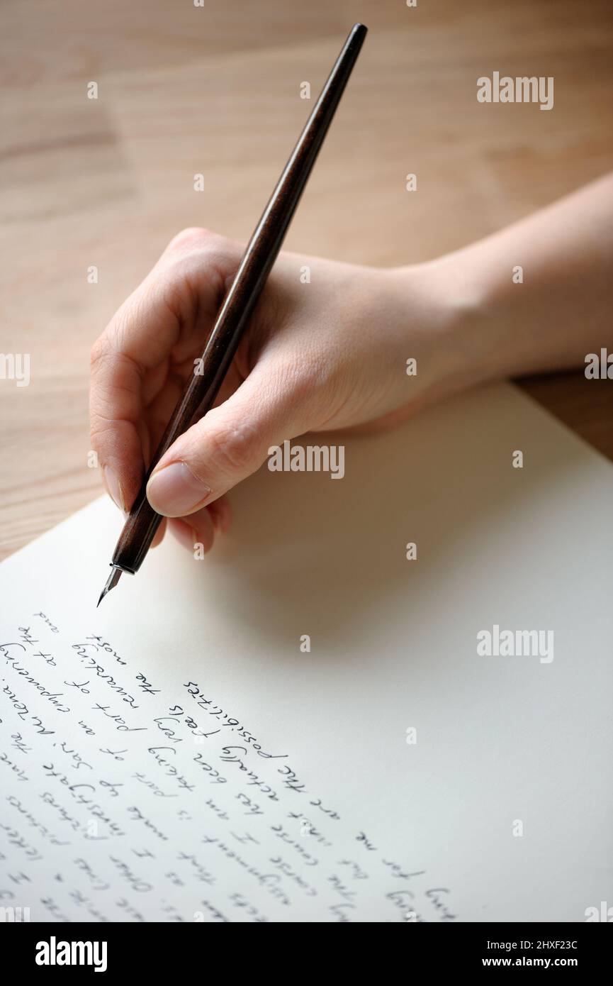 Writing letter to a friend. Hand holding a fountain pen Stock Photo - Alamy