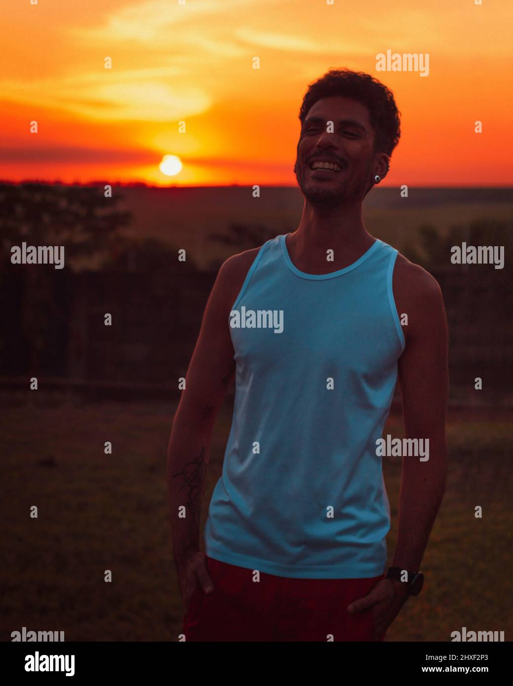 Adult black man at sunset blackground Stock Photo - Alamy