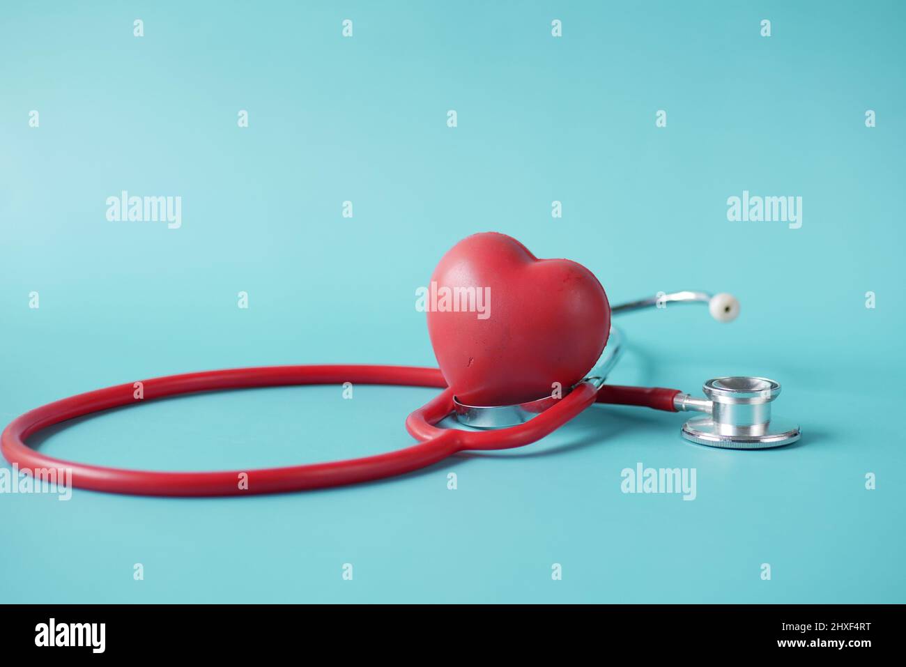 heart shape symbol and stethoscope on green background Stock Photo - Alamy