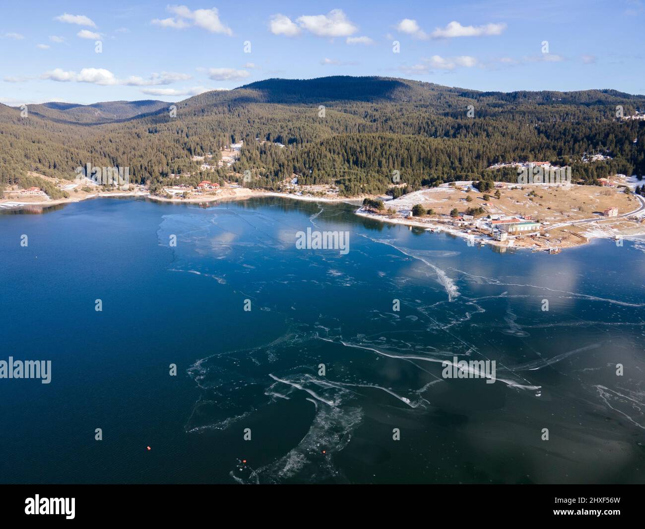 Aerial winter view of Dospat Reservoir covered with ice, Smolyan Region