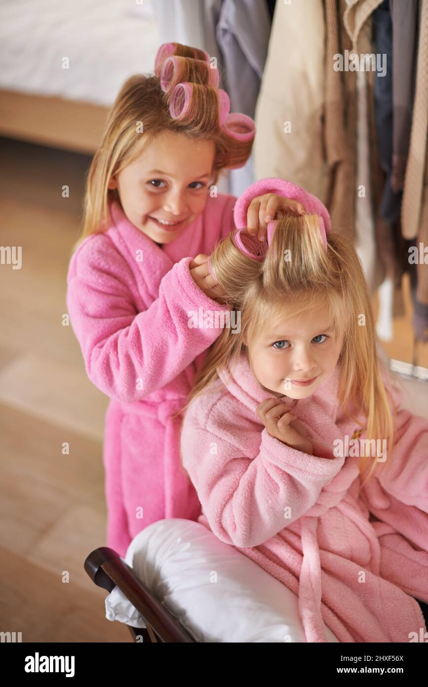 Pretending theyre at the beauty salon. Cropped shot of two young sisters playing with moms makeup. Stock Photo