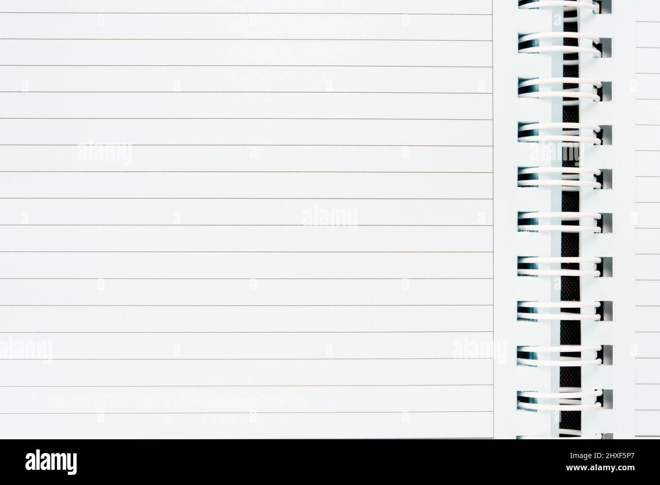 An open spiral notebook with blank page. Stock Photo