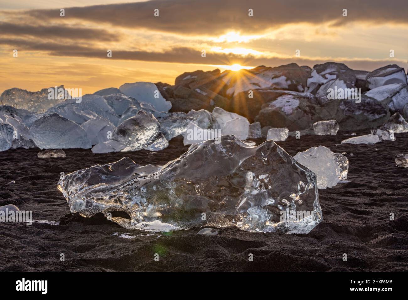 sun shining through ice at Diamond Beach, Breidamerkursandur, southeast Iceland Stock Photo