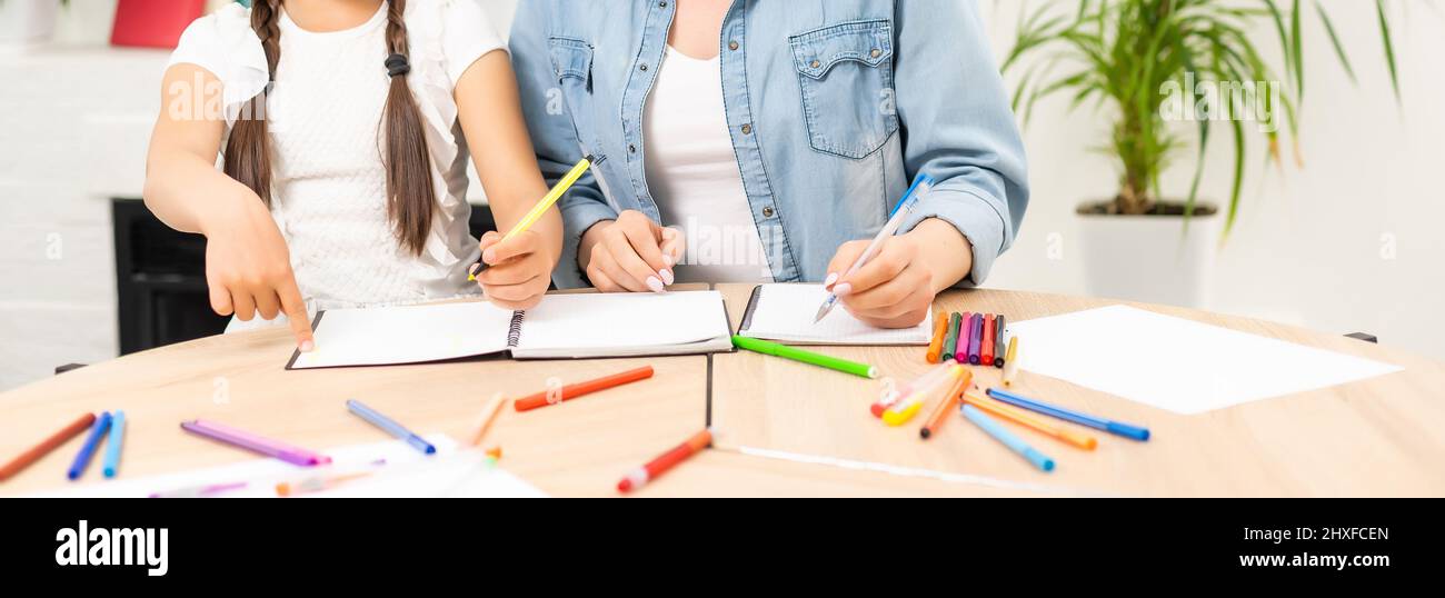 Mother and daughter spending time together at home drawing Stock Photo ...