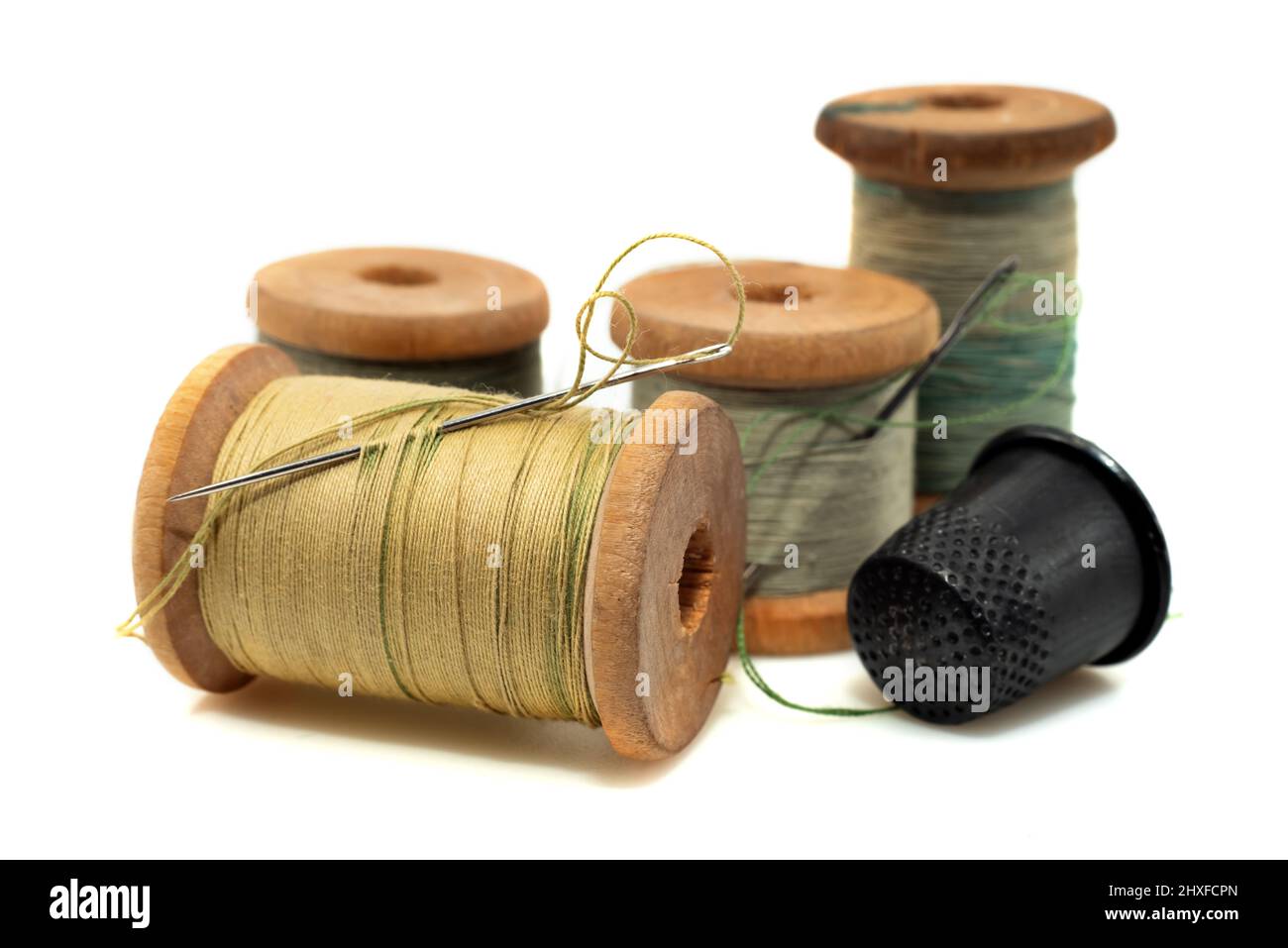 Premium Photo  A bobbin of thread with a needle and a thimble