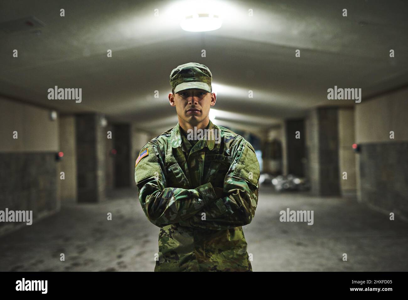 Some people are afraid of the dark, I welcome it. Shot of a young soldier standing outside on a cold night at a military academy. Stock Photo