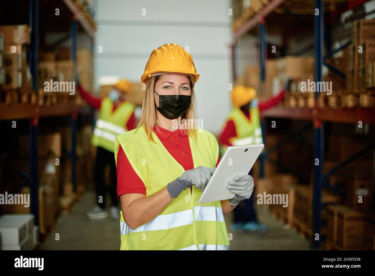 Man in mask using tablet Stock Photo