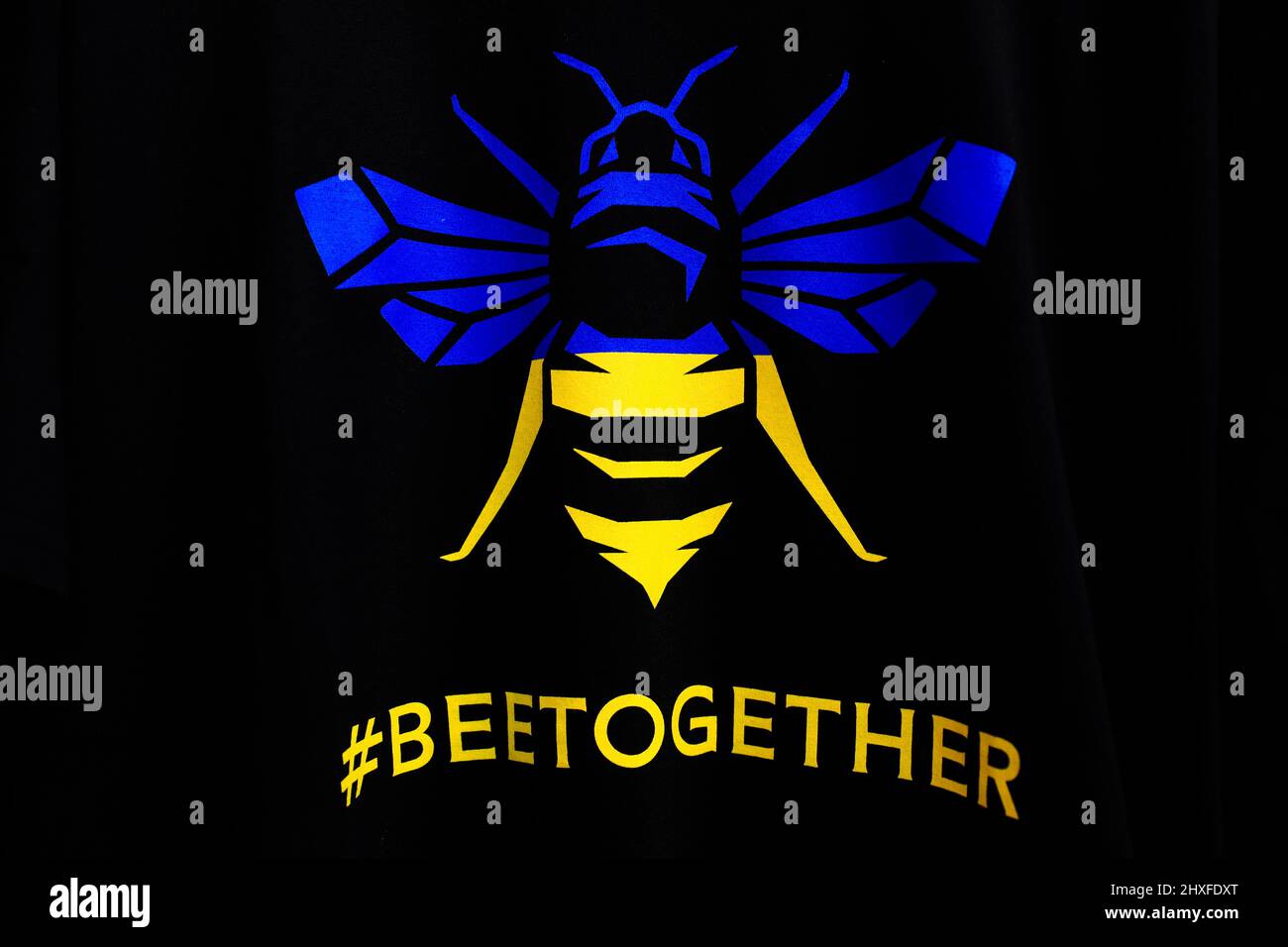 12th March 2022 ; Brentford Community Stadium, London, England; Premier League football, Brentford versus Burnley; A special Brentford t-shirt featuring the Brentford Bee symbol with the national colours of the Ukraine and the hashtag &quot;#beetogether&quot; Credit: Action Plus Sports Images/Alamy Live News Stock Photo