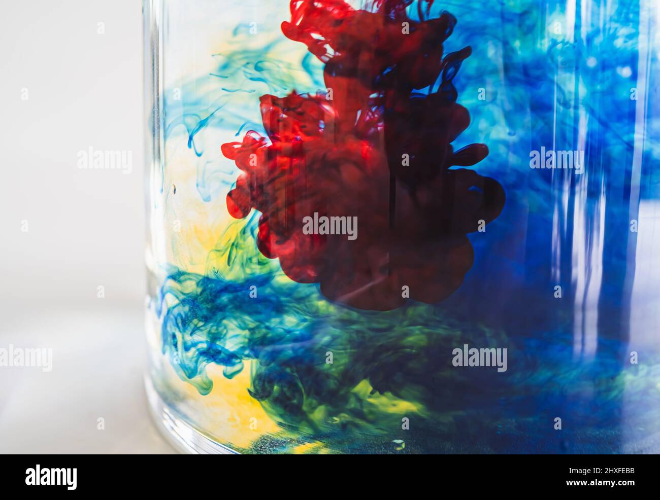 color drops in water glass Stock Photo - Alamy