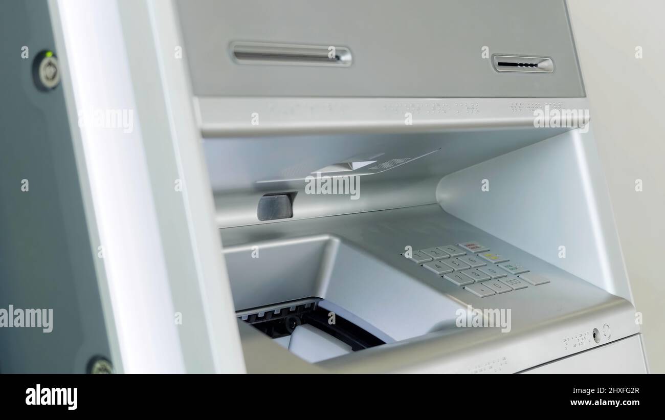 ATM bank machine and male hand performing financial transactions. HDR ...