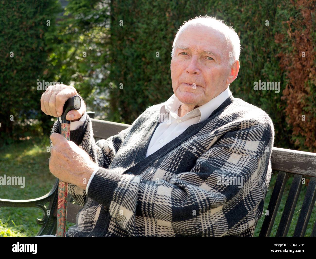 old man enjoys sitting on a bench in his garden Stock Photo - Alamy