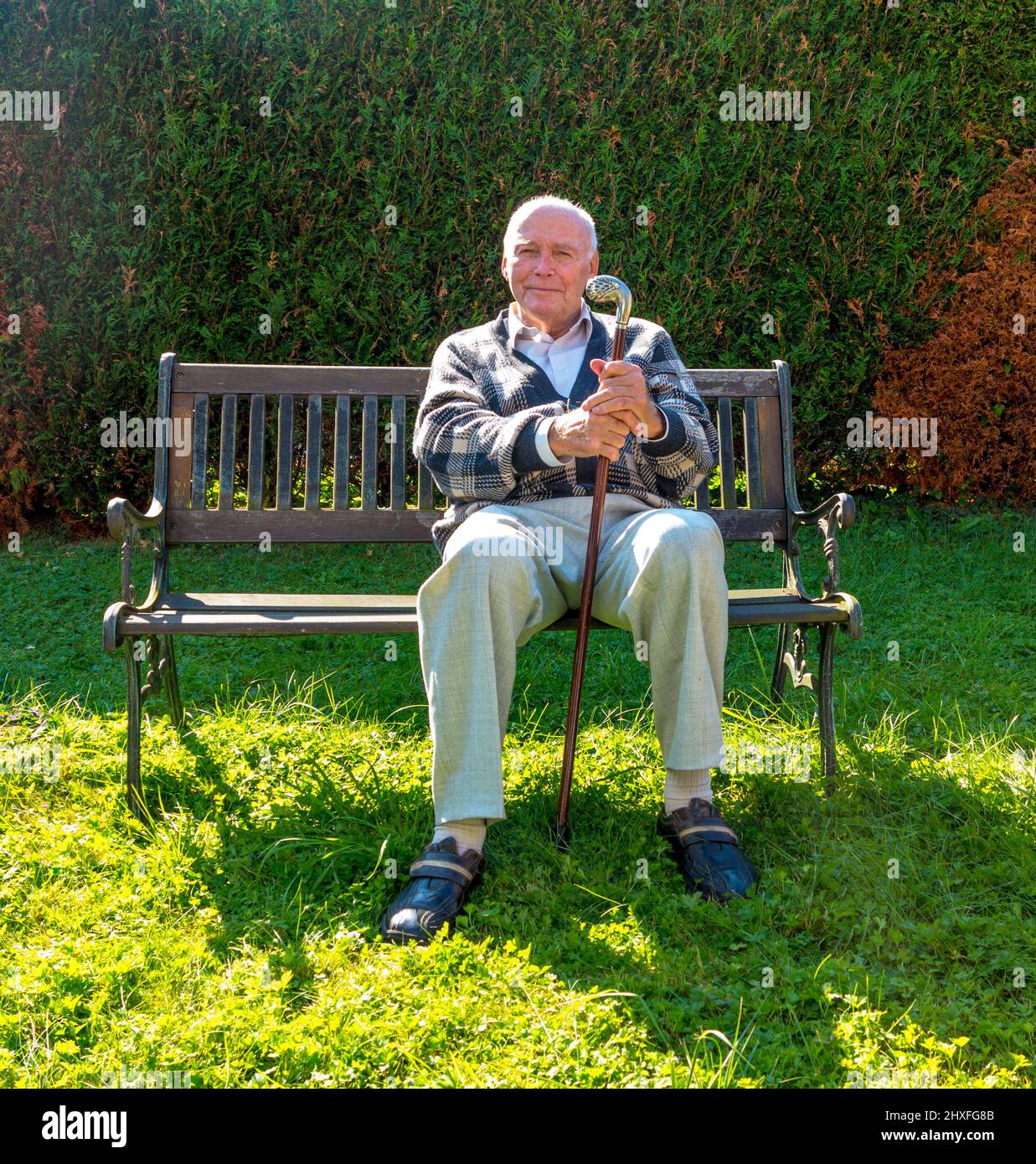 old man enjoys sitting on a bench in his garden Stock Photo - Alamy