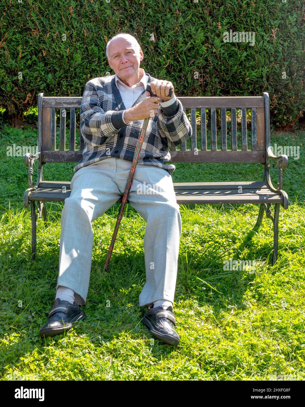 old man enjoys sitting on a bench in his garden Stock Photo - Alamy