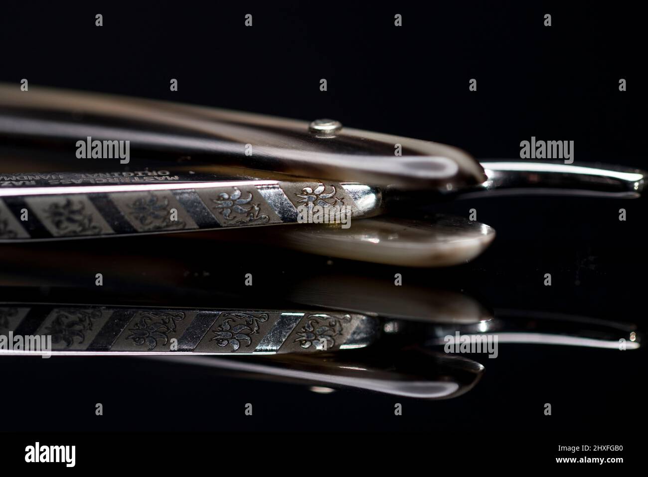Straight razor spine detail cut throat razor and scales close up. Stock Photo