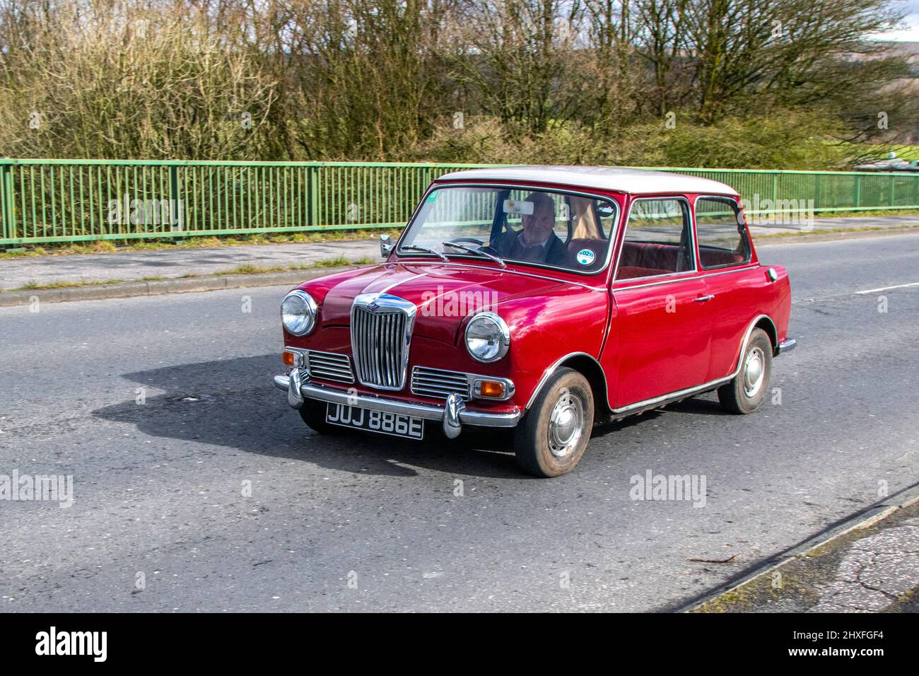 1967 605 red  Riley Elf Mk.III 998cc petrol 2dr saloon; Vehicular traffic, moving vehicles, cars, vehicle driving on UK roads, motors, motoring on the UK road network near Manchester. Stock Photo