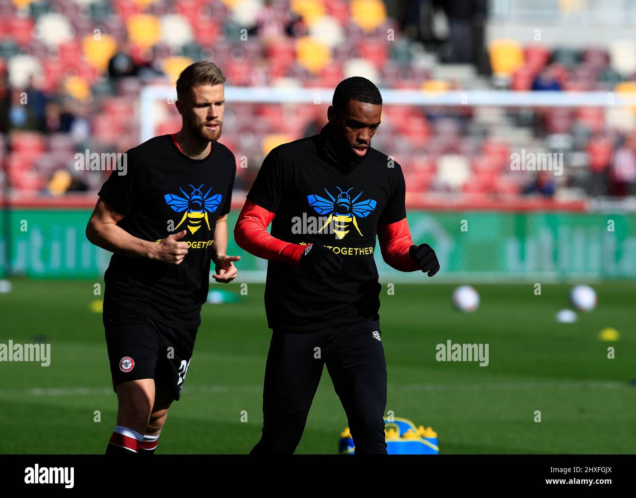 12th March 2022 ; Brentford Community Stadium, London, England; Premier League football, Brentford versus Burnley; Ivan Toney of Brentford wearing a special Brentford Bee symbol with the national colours of the Ukraine and the hashtag &quot;#beetogether&quot; before kick off Credit: Action Plus Sports Images/Alamy Live News Stock Photo