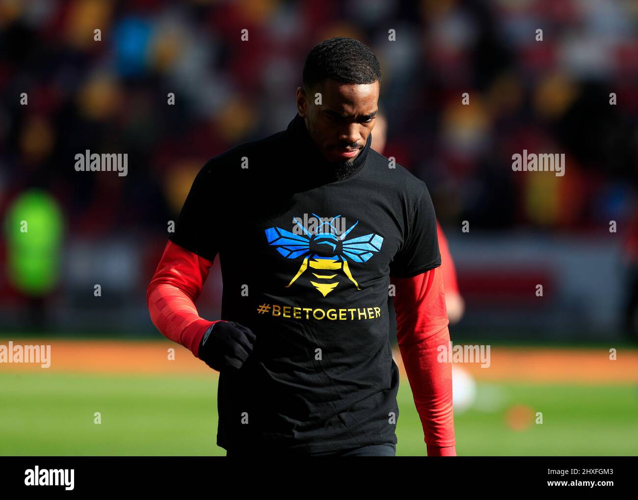 12th March 2022 ; Brentford Community Stadium, London, England; Premier League football, Brentford versus Burnley; Ivan Toney of Brentford wearing a special Brentford Bee symbol with the national colours of the Ukraine and the hashtag &quot;#beetogether&quot; before kick off Credit: Action Plus Sports Images/Alamy Live News Stock Photo