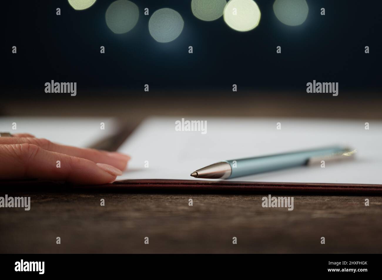Low angle view of a pen lying on document, contract or application form in a folder. Stock Photo