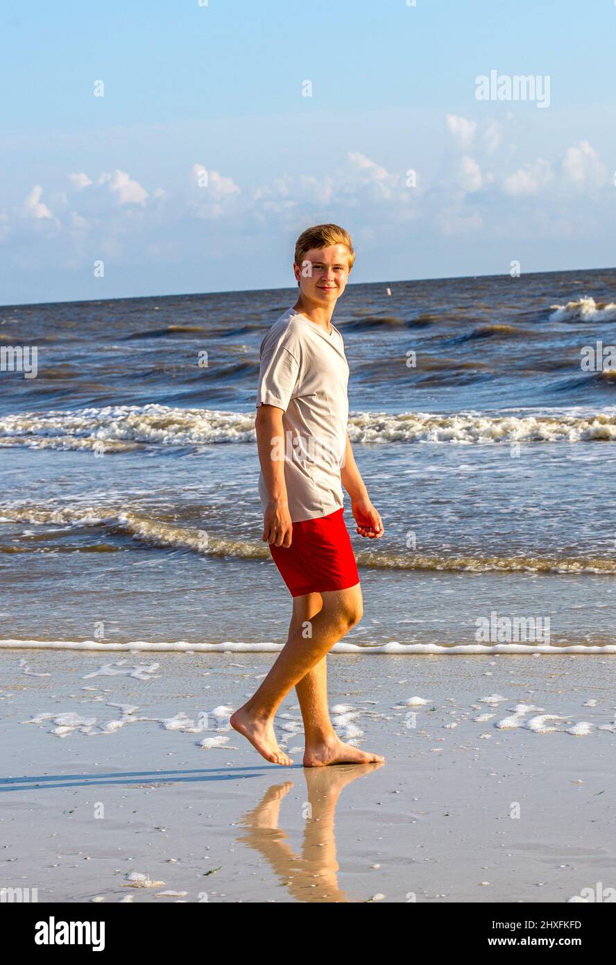 teenager enjoys jogging along the beautiful beach Stock Photo