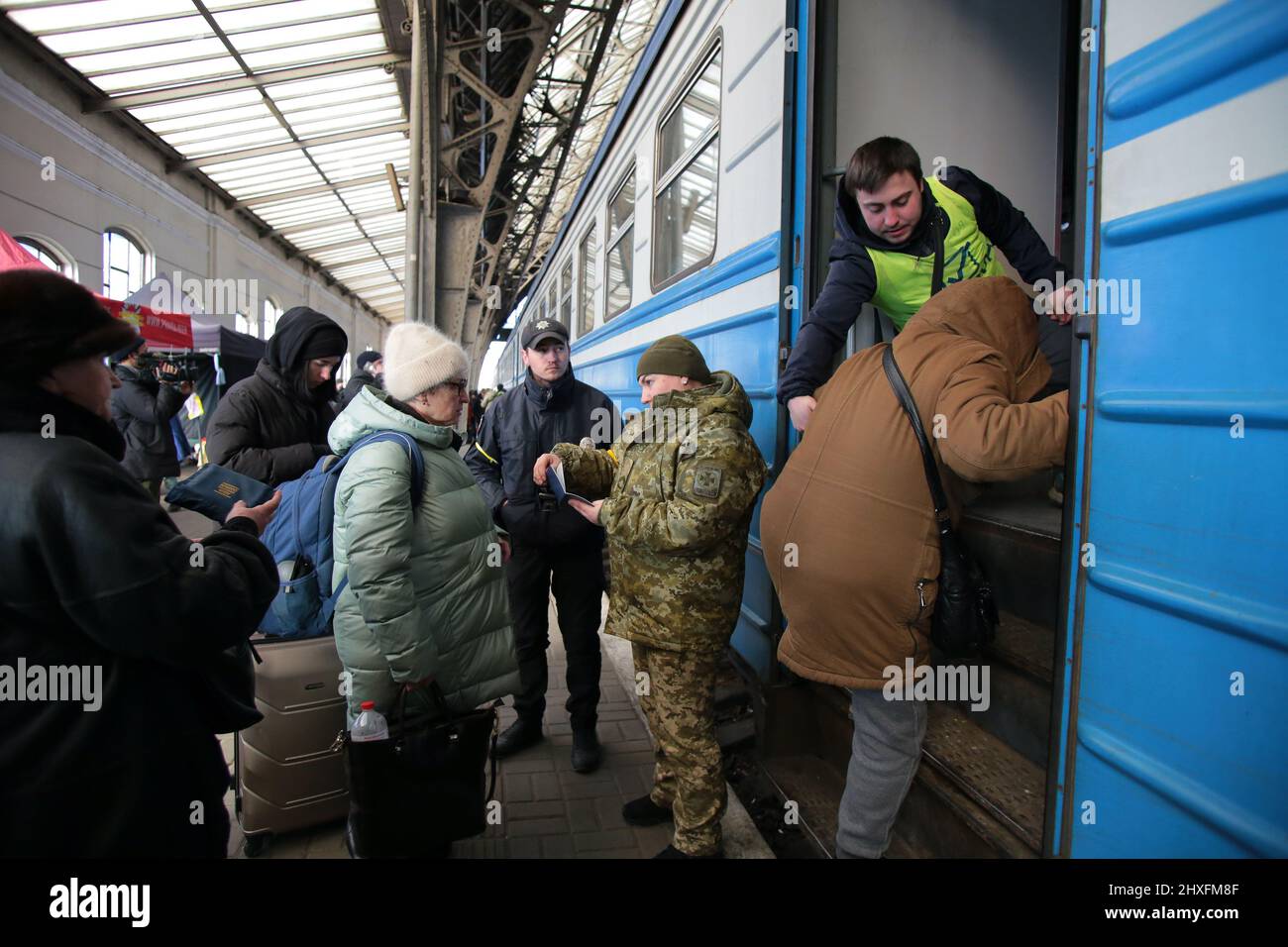 LVIV, UKRAINE - MARCH 11, 2022 - People fleeing the Russian invasion await an evacuation train to Przemysl, Poland, at the main railway station in Lvi Stock Photo