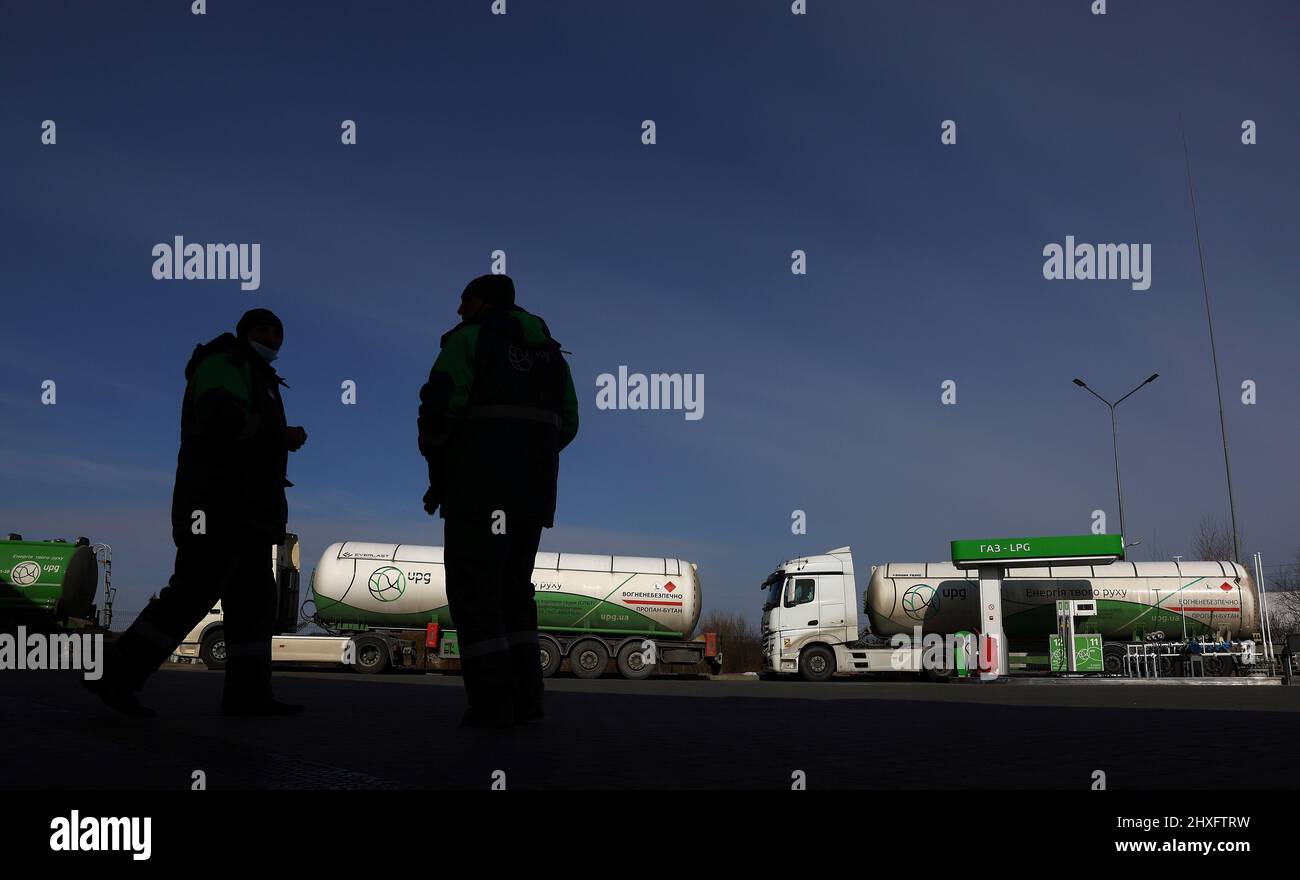 Empty fuel trucks are parked at a gas station which was running out of