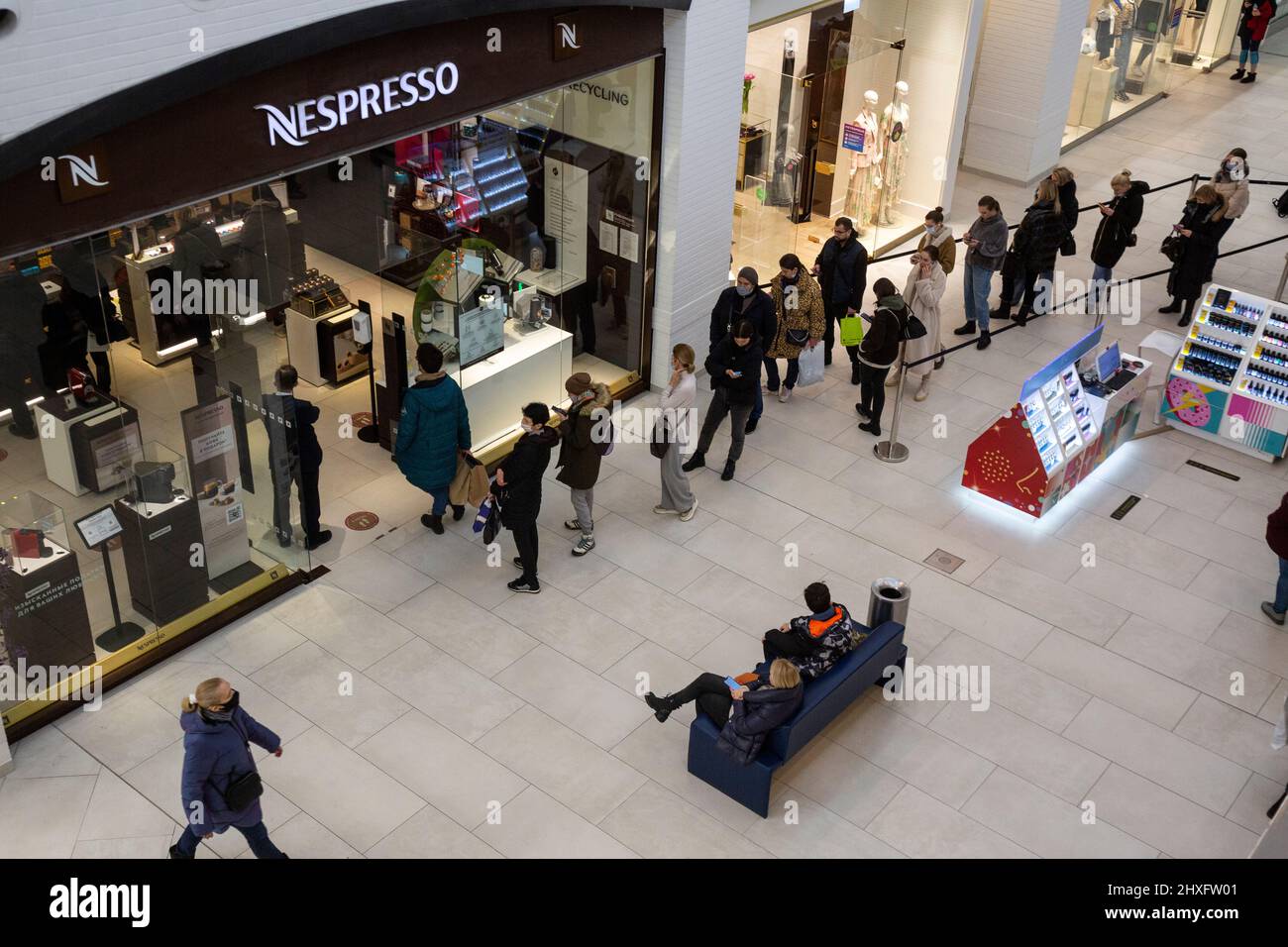 Moscow, Russia. 12th of March, 2022 Customers stay in queue to a Nespresso  store at the Metropolis shopping mall in Moscow, Russia. The Swiss company  Nestle decided not import products in Russia