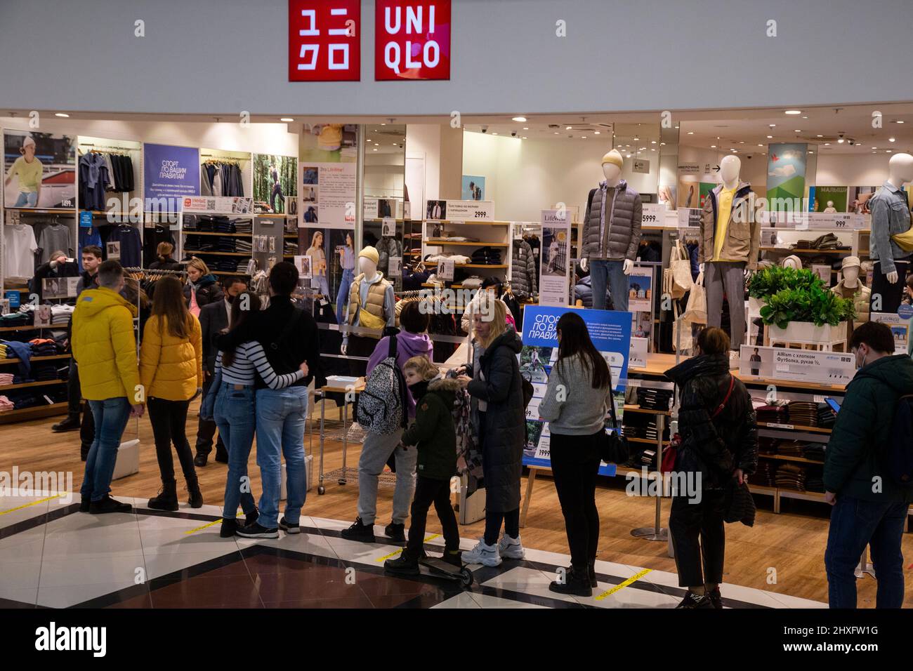 Moscow, Russia. 12th of March, 2022 Customers stay in queue to a Uniqlo  store at the Metropolis shopping mall in Moscow, Russia. Uniqlo, a major  Japanese clothes manufacturer and retailer, decided to